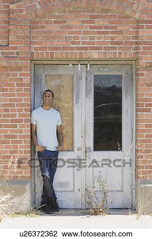Young man at abandoned building View Large Photo Image Stock Image - Young man at abandoned building. Fotosearch
