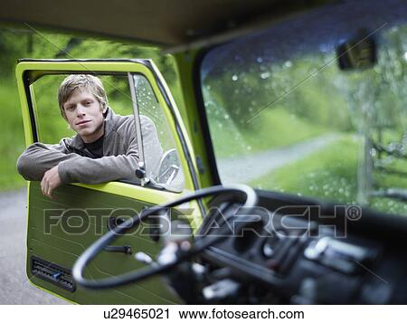 Stock Image - Young man hanging on door. Fotosearch