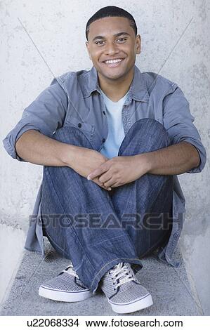 Young man sitting View Large Photo Image Picture - Young man sitting. Fotosearch
