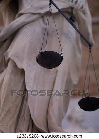 Stock Photo - A statue holding scales in Venice. Fotosearch