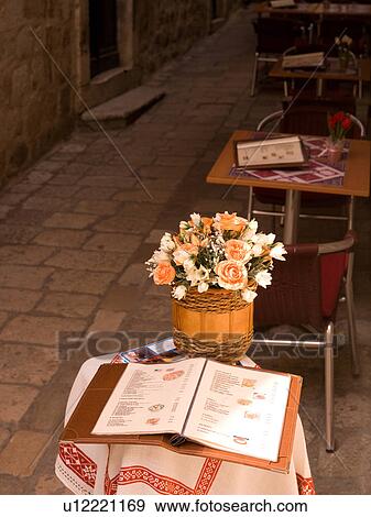 Stock Photo - Basket of flowers on a table in Dubrovnik. Fotosearch