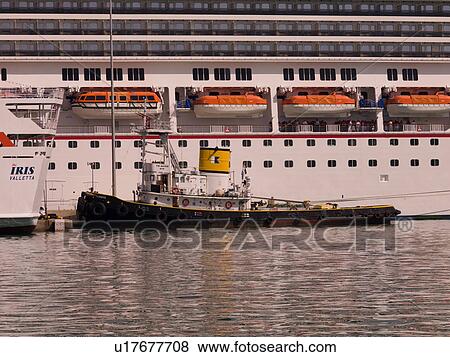 Boat along cruise ship in Katakolon View Large Photo Image Stock Photo - Boat along cruise ship in Katakolon. Fotosearch
