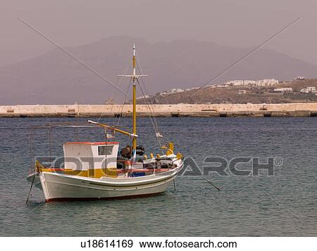 Stock Photo - Boat off shoreline of Mykonos Greece. Fotosearch