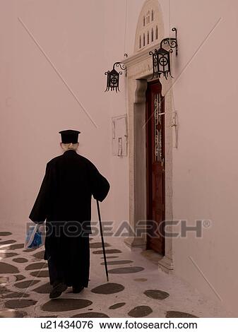 Stock Photograph - Elderly man with a cane in Mykonos Greece. Fotosearch