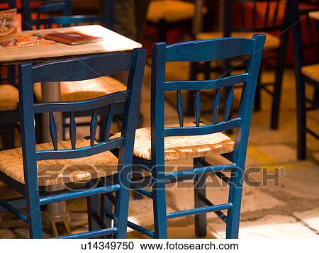 Stock Image - Empty restaurant chairs in Athens Greece. Fotosearch