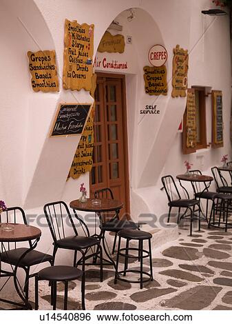 Empty table and stools in Mykonos Greece View Large Photo Image Stock Photograph - Empty table and stools in Mykonos Greece. Fotosearch
