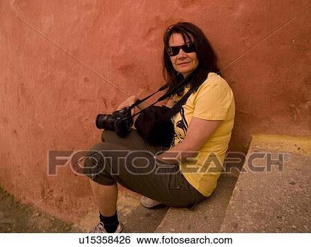 Stock Photograph - Female tourist with a camera in Rhodes Greece. Fotosearch
