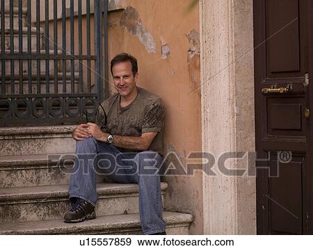 Stock Photo - Male posing on steps in Rome Italy. Fotosearch