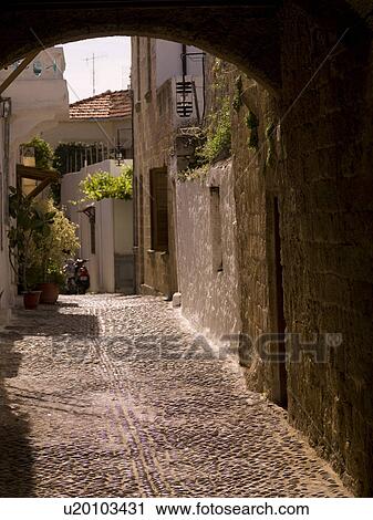 Stock Image - Narrow street in Rhodes Greece. Fotosearch