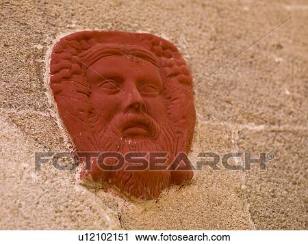 Stock Image - Painted face on a wall in Rhodes Greece. Fotosearch