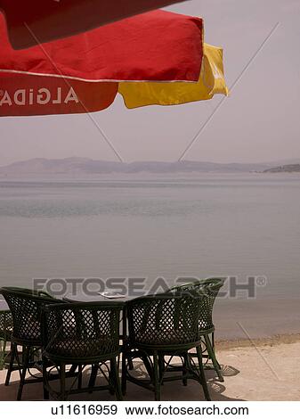 Stock Photo - Patio furniture along seashore in Kusadasi Turkey. Fotosearch