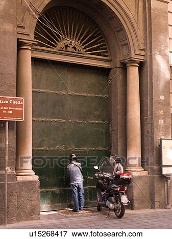 Stock Photo - People opening a door in Naples. Fotosearch