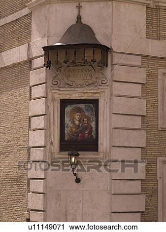 Stock Image - Religious painted plaque on building in Rome Italy. Fotosearch