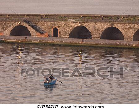 Stock Photo - Row boat along the Naples shoreline. Fotosearch