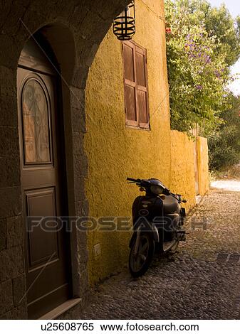Stock Photography - Scooter outside doorway in Rhodes Greece. Fotosearch
