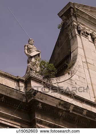 Stock Image - Statue on rooftop in Rome Italy. Fotosearch