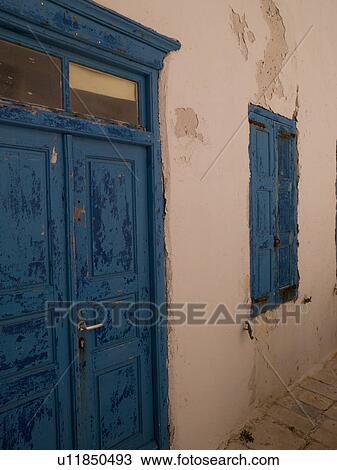 Stock Image - Weathered blue door in Mykonos Greece. Fotosearch