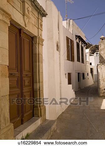 Picture - Wooden door and stone wall in Rhodes Greece. Fotosearch