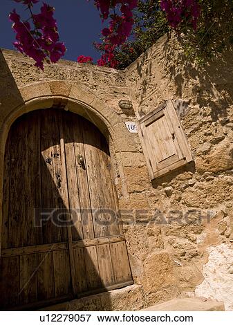 Wooden door and stone wall in Rhodes Greece View Large Photo Image Stock Photo - Wooden door and stone wall in Rhodes Greece. Fotosearch