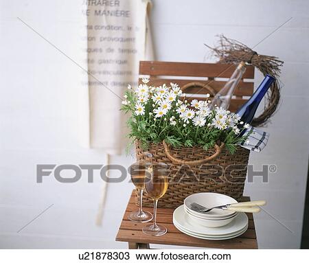 A basket of wildflowers on a chair with two glasses of wine and some crockery View Large Photo Image Stock Image - A basket of wildflowers on a chair with two glasses of wine and some crockery. Fotosearch