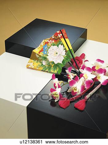 Stock Image - A fan, orchids and tassels. Fotosearch