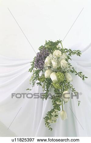 Stock Photo - A large bouquet of flowers against a draped cloth background. Fotosearch