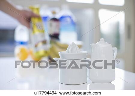 A lemon squeezer and milk pot View Large Photo Image Picture - A lemon squeezer and milk pot. Fotosearch