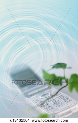 Picture - A mobile phone in rippled water. Fotosearch