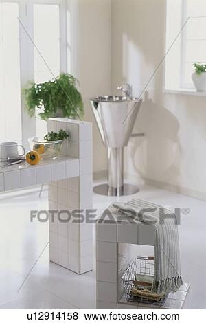 Stock Photo - A modern kitchen with tiled walls and a hand basin. Fotosearch
