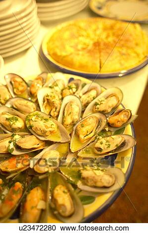 Stock Image - A Platter of Mussels and Spanish Potato Omelet. Tokyo Prefecture, Japan. Fotosearch