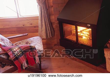 A Rocking Chair in front of a Fireplace View Large Photo Image Stock Image - A Rocking Chair in front of a Fireplace. Fotosearch