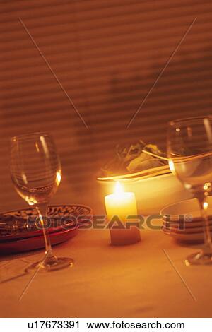 Stock Image - A Table with Plates, Wineglasses and a Candle. Fotosearch