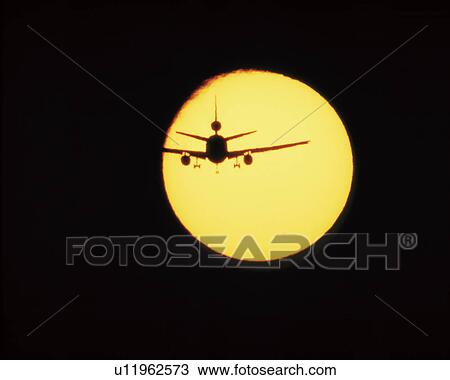 Stock Image - Airplane and sun. Fotosearch