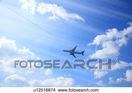 Picture - Airplane in blue sky. Fotosearch