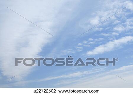 Stock Image - Airplane in the blue sky, copy space, Tokyo prefecture, Japan. Fotosearch