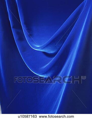 Stock Image - An elegantly-draped cloth hanging. Fotosearch