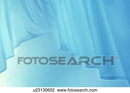 Stock Image - An elegantly-draped cloth hanging. Fotosearch