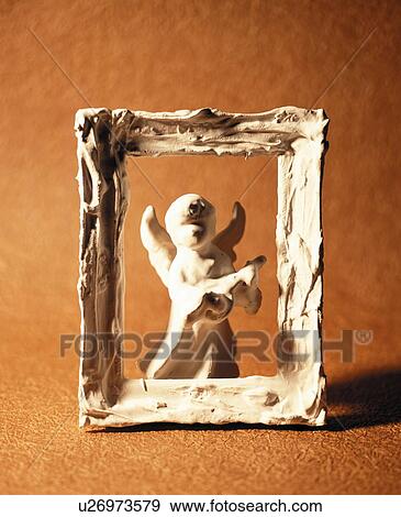 Stock Photo - Angel figurine and frame. Fotosearch