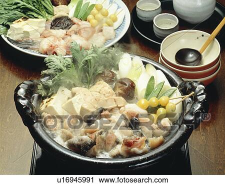 Stock Image - Anglerfish and vegetables cooked in crock pot. Fotosearch