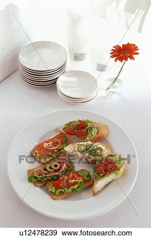 Stock Photo - Appetizer breads with stacked plates and flower. Fotosearch
