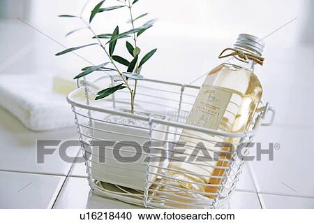 Aromatherapy bath oil in a basket with a plant View Large Photo Image Stock Image - Aromatherapy bath oil in a basket with a plant. Fotosearch
