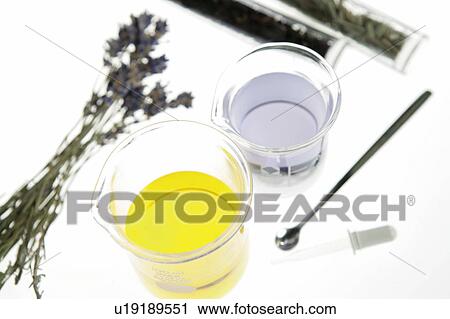 Stock Image - Aromatherapy oil in beakers, white background. Fotosearch