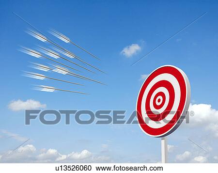 Stock Image - Arrows approaching the bull's eye with sky in background. Fotosearch