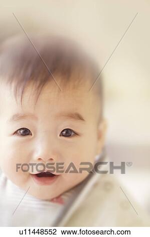 Baby boy smiling at the camera View Large Photo Image Stock Image - Baby boy smiling at the camera. Fotosearch