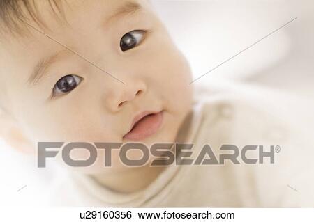 Baby boy smiling at the camera View Large Photo Image Stock Photograph - Baby boy smiling at the camera. Fotosearch