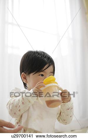 Baby girl drinking from bottle View Large Photo Image Stock Image - Baby girl drinking from bottle. Fotosearch