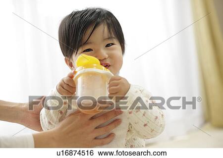 Baby girl drinking from bottle View Large Photo Image Stock Photograph - Baby girl drinking from bottle. Fotosearch