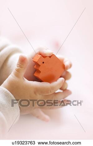 Baby holding orange toy block View Large Photo Image Stock Image - Baby holding orange toy block. Fotosearch