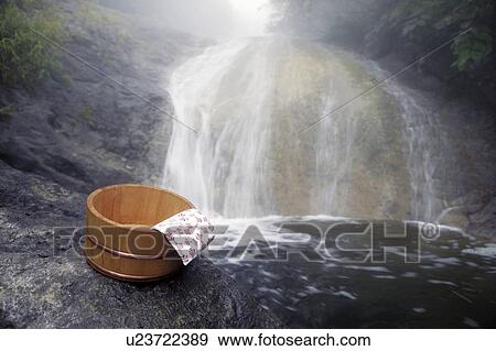 Stock Photo - Bamboo bucket and cloth by Kamuiwakka waterfall, Shari-machi, Hokkaido, Japan. Fotosearch