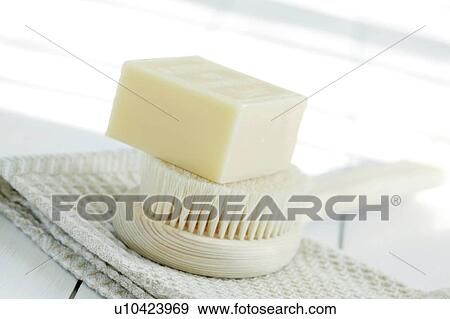 Stock Photo - Bar of soap with cloth and back brush. Fotosearch